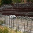 FILE - A vehicle drives along the U.S. side of the US-Mexico border wall in Nogales, Ariz., June 25, 2024. The Biden administration is making asylum restrictions at the southern border even tougher. The changes come in the middle of an election campaign where border security is a key concern for voters, and the administration is increasingly eager to show voters it's taking a hard stance. (AP Photo/Jae C. Hong, Pool, File)