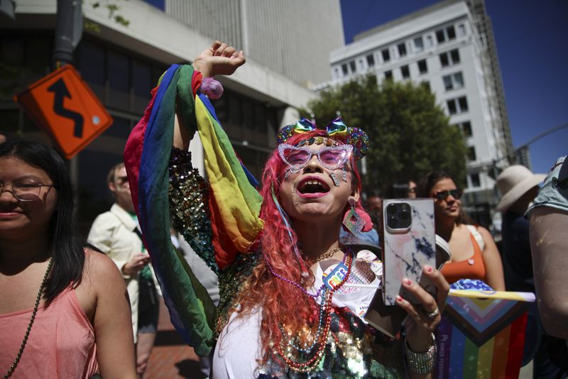 Revelers cheer during a Pride Parade, Sunday, June 30, 2024, in San Francisco. (AP Photo/Ethan Swope)