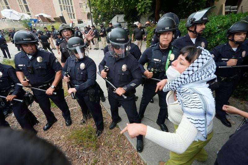 Police officers face off against pro-Palestinian protesters on the campus of UCLA on Thursday, May 23, 2024, In Los Angeles. (AP Photo/Damian Dovarganes)