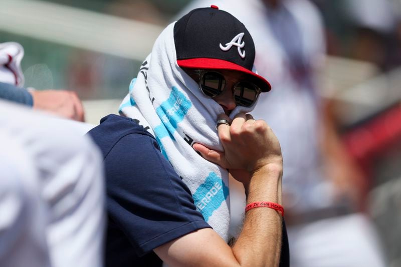 Atlanta Braves starting pitcher Max Fried uses a towel to shield himself from the sun during the fifth inning of their game against the Milwaukee Brewers at Truist Park, Thursday, August 8, 2024, in Atlanta. (Jason Getz / AJC)
