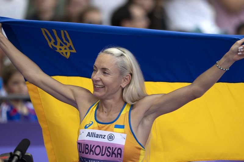 Oksana Zubkovska, of Ukraine, celebrates after winning the Women's Long Jump -T12 at the Stade de France stadium, during the 2024 Paralympics, Sunday, Sept. 1, 2024, in Paris, France. (AP Photo/Emilio Morenatti)