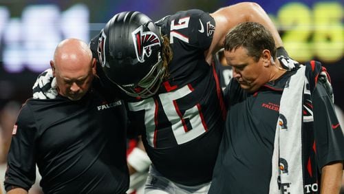 Atlanta Falcons offensive tackle Kaleb McGary (76) is carried by Falcons medical staff after an injury during the first half on Sunday, Sept. 22, 2024, at Mercedes-Benz Stadium in Atlanta. 
(Miguel Martinez/ AJC)