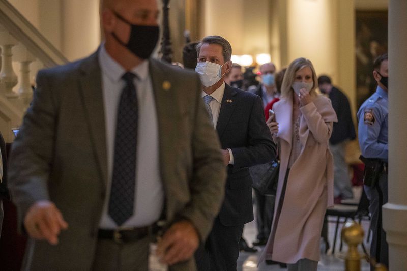 Gov. Brian Kemp returns to his office following a COVID-19 press conference at the Georgia State Capitol. (Alyssa Pointer / Alyssa.Pointer@ajc.com)