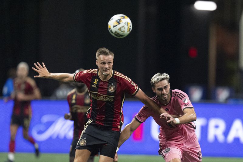 Atlanta United defender Stian Gregersen (5) and Inter Miami forward Leonardo Campana (8) battle for the ball during thre first half of a MLS soccer match Wednesday, Sept. 18, 2024. (AP Photo/John Bazemore)