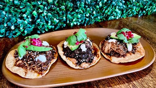 Delivered on three crisp, house-made tostadas, Patria Cocina’s tostadas de mole negro can be an appetizer or an entree. (Angela Hansberger for The Atlanta Journal-Constitution)