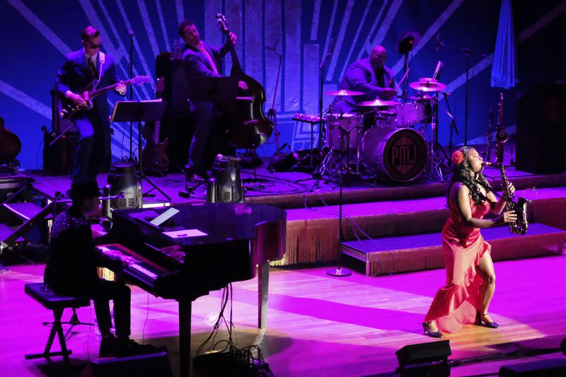 Members of the band Postmodern Jukebox perform on stage at the Ryman Auditorium during a concert in Nashville, Tenn., on July 30, 2024. (AP Photo/Luis Andres Henao)