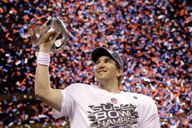 FILE - New York Giants quarterback Eli Manning holds up the Vince Lombardi Trophy while celebrating his team's 21-17 win over the New England Patriots in the NFL Super Bowl XLVI football game, Sunday, Feb. 5, 2012, in Indianapolis. (AP Photo/David J. Phillip, File0