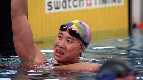 Chinese swimmer Le Jingyi celebrates her victory in the 100 meter freestyle competition at the Georgia Tech Aquatic Center during the 1996 Summer Olympic Games in Atlanta. (David Tuilis/AJC)