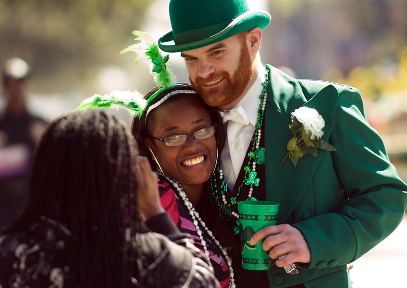 A man dressed as a leprechaun has his picture taken with a woman during Savannah's annual St. Patrick's Day Parade in 2011. (AP Photo/Stephen Morton)