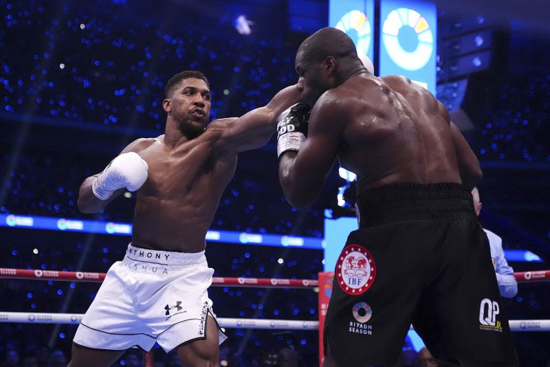 Anthony Joshua, left, and Daniel Dubois fight in the IBF World Heavyweight bout at Wembley Stadium, in London, Saturday, Sept. 21, 2024. (Bradley Collyer/PA via AP)