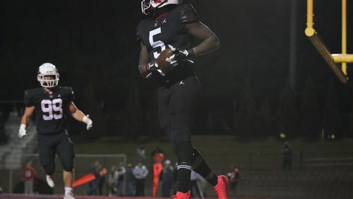 Milton running back Jordan McDonald (5) carries the ball for a touchdown against Cherokee in the first half of play Friday, Nov. 5, 2021 at Milton High School. (Daniel Varnado/ For the Atlanta Journal-Constitution)