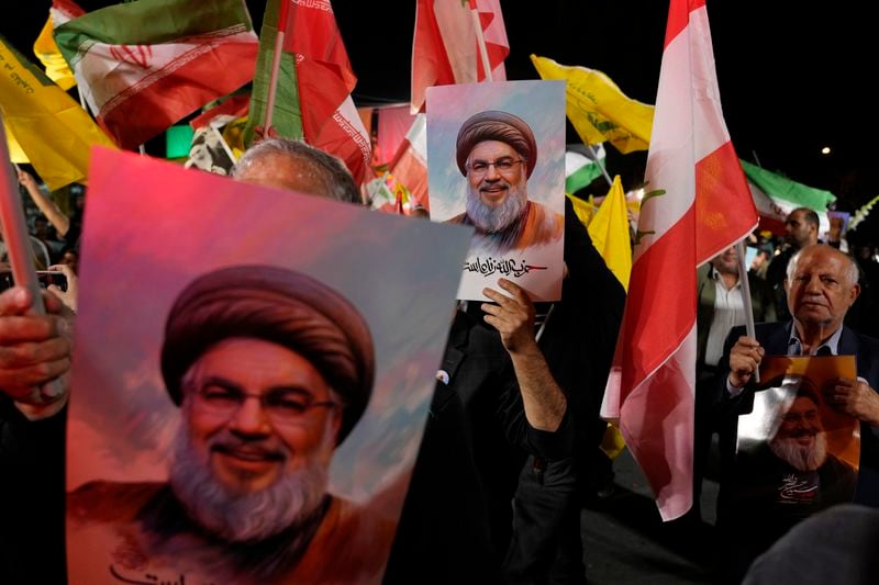 Iranian demonstrators hold posters of slain Hezbollah leader Hassan Nasrallah during an anti-Israeli protest at Felestin (Palestine) Square in Tehran, Iran, Tuesday, Oct. 1, 2024. (AP Photo/Vahid Salemi)