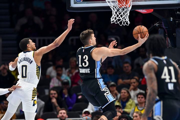 Atlanta Hawks guard Bogdan Bogdanovic (13) drives to the basket against Indiana Pacers guard Tyrese Haliburton (0) during the first half of an NBA game Tuesday, November 21, 2023. (Daniel Varnado/For the AJC)