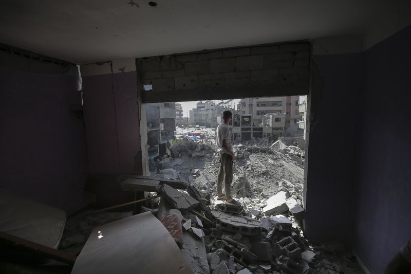 A Palestinian looks at the aftermath of the Israeli bombing in Nuseirat refugee camp, Gaza Strip, Saturday, June 8, 2024. (AP Photo/Jehad Alshrafi)