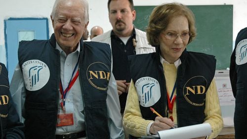 Former President Jimmy Carter (left) and his wife, Rosalynn, observe the 2006 Palestinian parliamentary elections as part of an 80-member delegation, organized by the Carter Center and the National Democratic Institute. (Courtesy of the Carter Center)