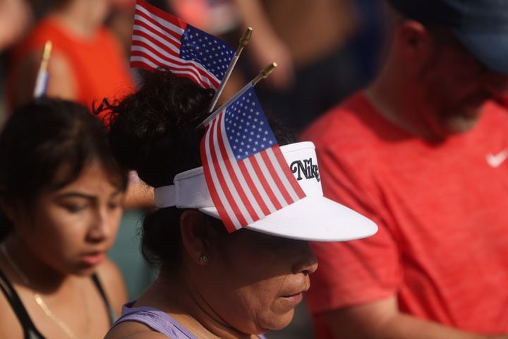 Runners show patriotism at the finish of the 55th running of the Atlanta Journal-Constitution Peachtree Road Race in Atlanta on Thursday, July 4, 2024.   (Jason Getz / AJC)