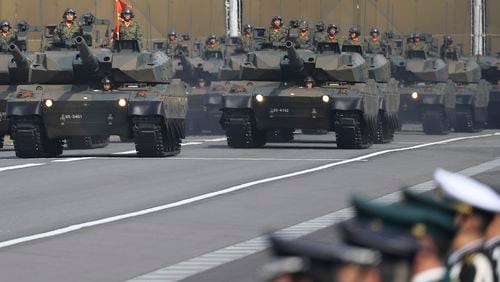 FILE - The Japan Ground Self-Defense Force tanks parade during the Self-Defense Forces Day at Asaka Base in Asaka, north of Tokyo, on Oct. 23, 2016. (AP Photo/Eugene Hoshiko, File)