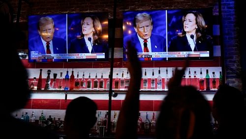 Viewers cheer as they watch a debate between Democratic presidential nominee Vice President Kamala Harris and Republican presidential nominee former President Donald Trump at the Angry Elephant Bar and Grill, Tuesday, Sept. 10, 2024, in San Antonio. (AP Photo/Eric Gay)