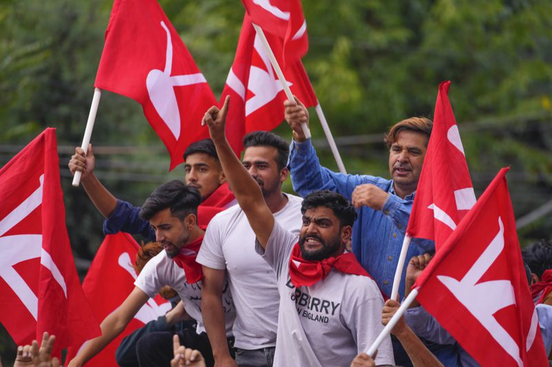 Supporters of National Conference party shout slogans as they celebrate early leads in the election for a local government in Indian controlled Kashmir, Srinagar, Tuesday, Oct. 8, 2024. (AP Photo/Dar Yasin)