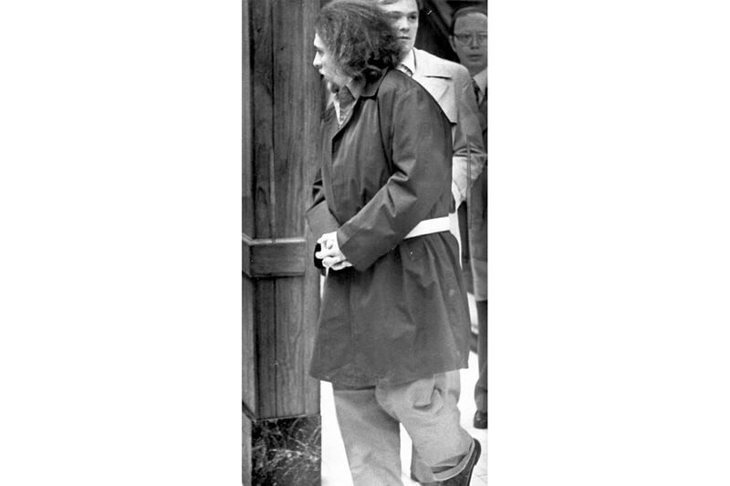 Steve Szarewicz is placed in handcuffs shortly after his arrest for the murder of Billy Merriwether outside Pittsburgh, on Dec. 9, 1981. (Pittsburgh Post-Gazette via AP)