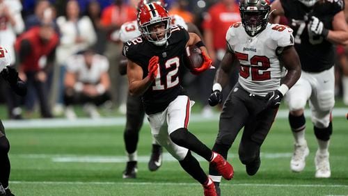 Atlanta Falcons wide receiver KhaDarel Hodge (12) outrusn Tampa Bay Buccaneers linebacker K.J. Britt (52) to the endzone to score the game-winning touchdown against the Tampa Bay Buccaneers during overtime in an NFL football game Friday, Oct. 4, 2024, in Atlanta. (AP Photo/John Bazemore)