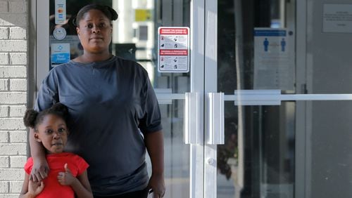 April Bryant poses for a portrait with her daughter Journee Bryant, 6, outside the Studio 6 they are living at in Duluth on Thursday, Aug. 12, 2021. (Christine Tannous / christine.tannous@ajc.com)