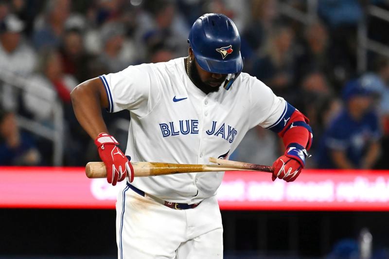 Toronto Blue Jays' Vladimir Guerrero Jr. (27) breaks his bat on a fly out in the fourth inning of a baseball game against the Philadelphia Phillies in Toronto on Tuesday Sept. 3, 2024. (Jon Blacker/The Canadian Press via AP)