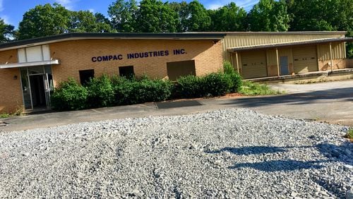 A portion of the six-acre site on Talley Street where the new Decatur school will get built. Most of the summer will be spent demoslishing several old commercial buildings and houses on the site, including this office building and warehouse. The school’s scheduled to open in August, 2019. Bill Banks for the AJC