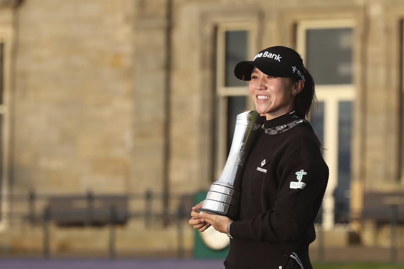 Lydia Ko of New Zealand, poses for the media with the trophy after winning the Women's British Open golf championship, and becoming Champion golfer, in St. Andrews, Scotland, Sunday, Aug. 25, 2024. (AP Photo/Scott Heppell)