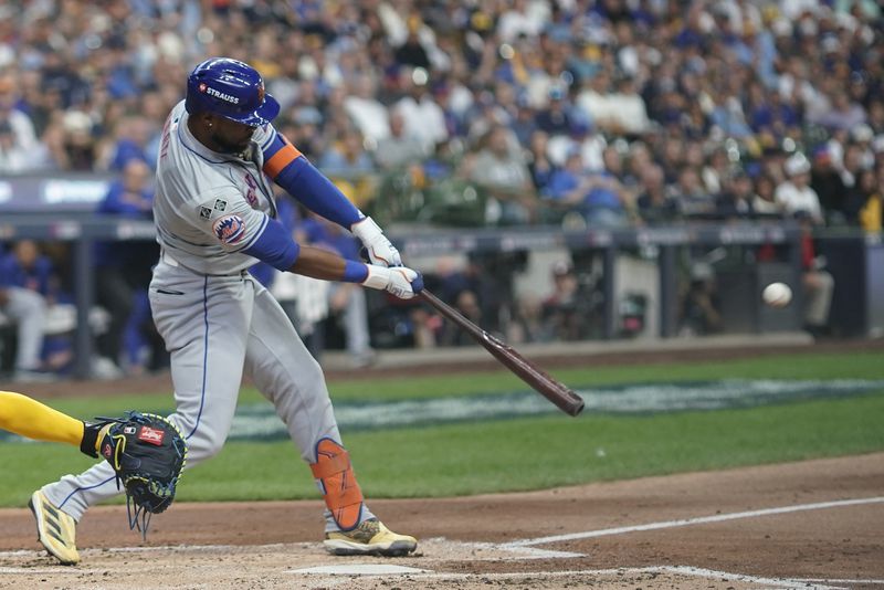 New York Mets' Starling Marte hits an RBI sacrifice fly ball during the second inning of Game 2 of a National League wild card baseball game against the Milwaukee Brewers Tuesday, Oct. 1, 2024, in Milwaukee. (AP Photo/Morry Gash)