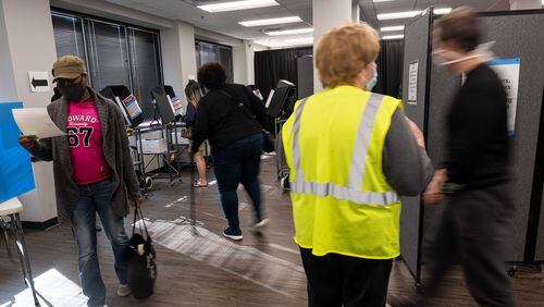 Kesha Johnson checks her printed ballot before casting it during early voting at the Cobb County Elections office in Marietta on Saturday, Dec. 19, 2020. (Photo: Ben Gray for The Atlanta Journal-Constitution)