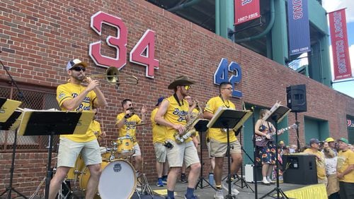 The Savannah Bananas' pep band entertains fan outside of Fenway Park on Saturday before a game against the Party Animals. (Adam Van Brimmer/AJC)