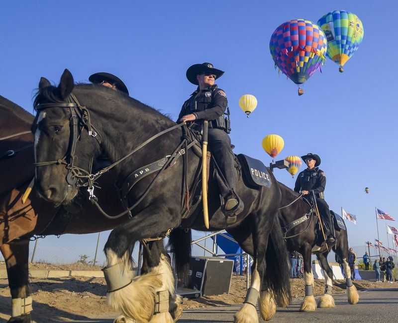 The Albuquerque Police Department's (APD) Horse Mounted Unit patrols during the 52nd Albuquerque International Balloon Fiesta in Albuquerque, N.M., on Saturday, Oct. 5, 2024. (AP Photo/Roberto E. Rosales)