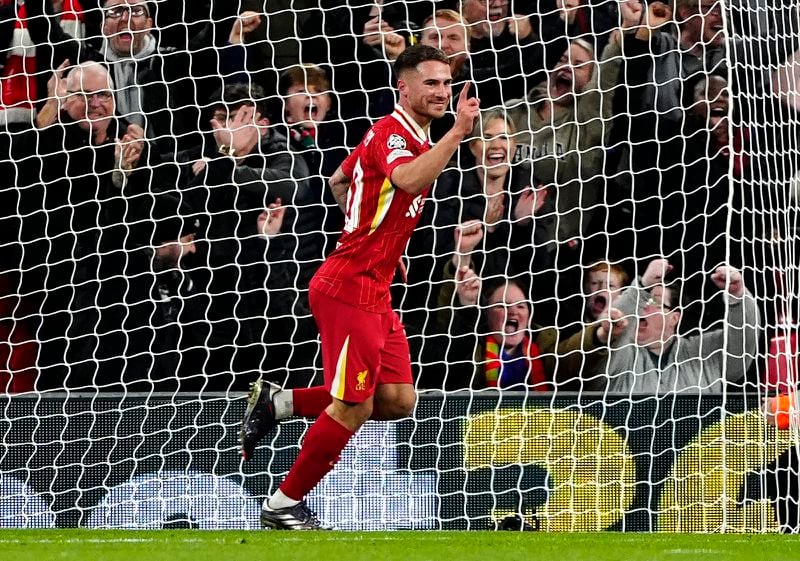 Liverpool's Alexis Mac Allister celebrates after scoring the opening goal during the Champions League opening phase soccer match between Liverpool and Bologna at the Anfield stadium in Liverpool, England, Wednesday, Oct. 2, 2024. (Peter Byrne/PA via AP)