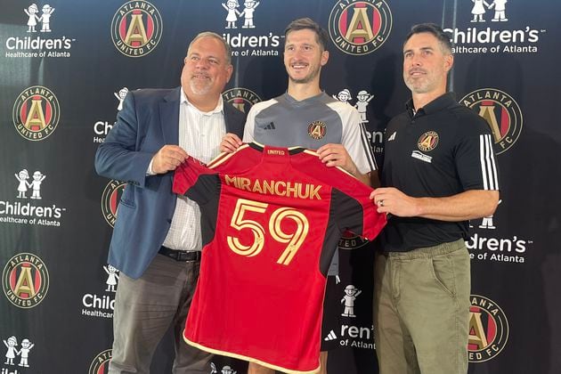 Atlanta United's Alexey Miranchuk (center), was introduced on Tuesday. He is seen here with President Garth Lagerwey (left), and Vice President Carlos Bocanegra (right).