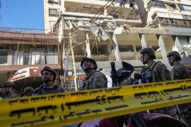 Lebanese soldiers cordon off the area at the site of an Israeli airstrike in Beirut's southern suburbs, Thursday, Sept. 26, 2024. (AP Photo/Hassan Ammar)