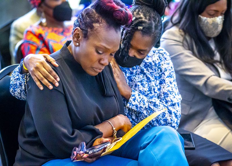 Wanda Cooper-Jones (L), the mother of the late Ahmaud Arbery, becomes emotional during an event in honor of her son at the National Center for Civil and Human Rights Wednesday, February 23, 2022.   STEVE SCHAEFER FOR THE ATLANTA JOURNAL-CONSTITUTION