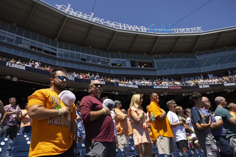 Fans stand for the playing of the national anthem before Tennessee plays against Texas A&M in Game 2 of the NCAA College World Series baseball finals in Omaha, Neb., Sunday, June 23, 2024. (AP Photo/Rebecca S. Gratz)