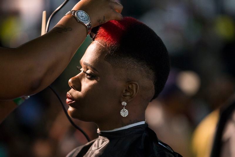 A model receives a stylish haircut during the Andis Total Look barbering competition at the 2018 Bronner Bros. show.  File photo by Alyssa Pointer/alyssa.pointer@ajc.com