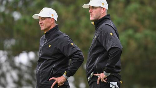 International team members Adam Scott, of Australia, left, and Taylor Pendrith, of Canada, look on during practice for the Presidents Cup golf tournament at Royal Montreal Golf Club in Montreal, Wednesday, Sept. 25, 2024. (Graham Hughes/The Canadian Press via AP)