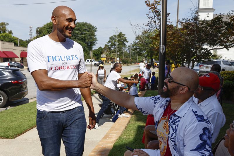 Alabama's new 2nd Congressional District Democratic candidate Shomari Figures greets voters during the Macon County Day Festival in Tuskegee, Ala., on Saturday, Aug 31, 2024. (AP Photo/ Butch Dill)