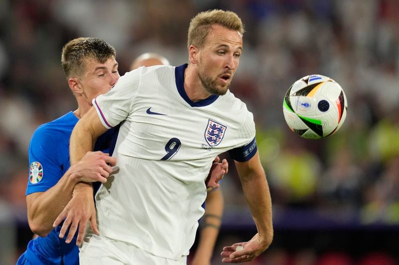 England's Harry Kane challenges for the ball with Slovenia's Jaka Bijol during a Group C match between the England and Slovenia at the Euro 2024 soccer tournament in Cologne, Germany, Tuesday, June 25, 2024. (AP Photo/Andreea Alexandru)