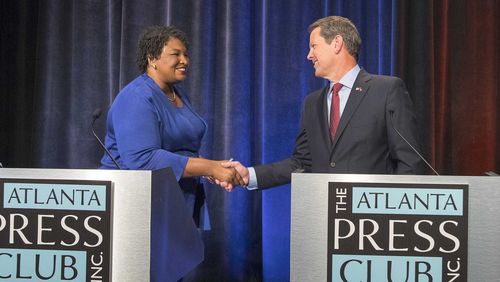 Democrat Stacey Abrams and Republican Brian Kemp greet each other before a 2018 debate, the first time the two ran against each other for governor. Abrams' campaign has been the subject of an investigation by the state ethics commission for 4 years over whether it illegally colluded with groups backing Abrams in that heated contest. (Alyssa Pointer/The Atlanta Journal-Constitution/TNS)