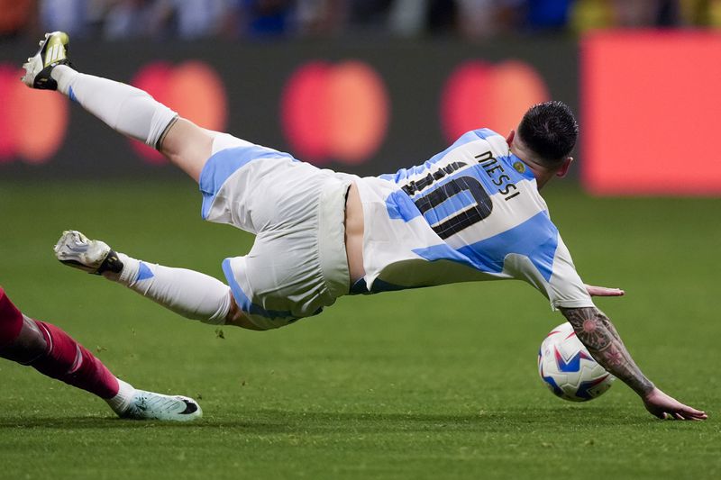 Argentina's Lionel Messi falls during a Copa America Group A soccer match against Canada in Atlanta, Thursday, June 20, 2024. (AP Photo/Mike Stewart)