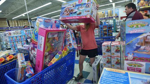 Helping out Santa: Jamie Staveness picks up a big box of a toy that was on someone's Christmas list.