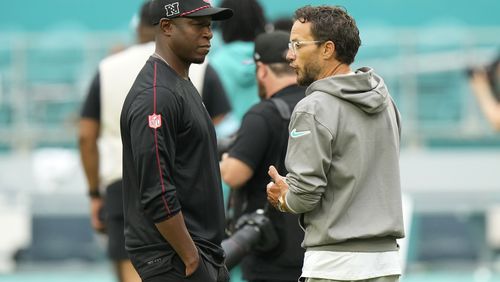 Atlanta Falcons head coach Raheem Morris, left, and Miami Dolphins head coach Mike McDaniel talks in the field before a pre season NFL football game, Friday, Aug. 9, 2024, in Miami Gardens, Fla. (AP Photo/Wilfredo Lee)