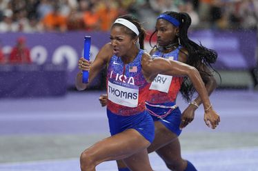 Gabrielle Thomas, of the United States, runs her leg of the women's 4x100-meter relay final at the 2024 Summer Olympics, Friday, Aug. 9, 2024, in Saint-Denis, France. (AP Photo/Matthias Schrader)