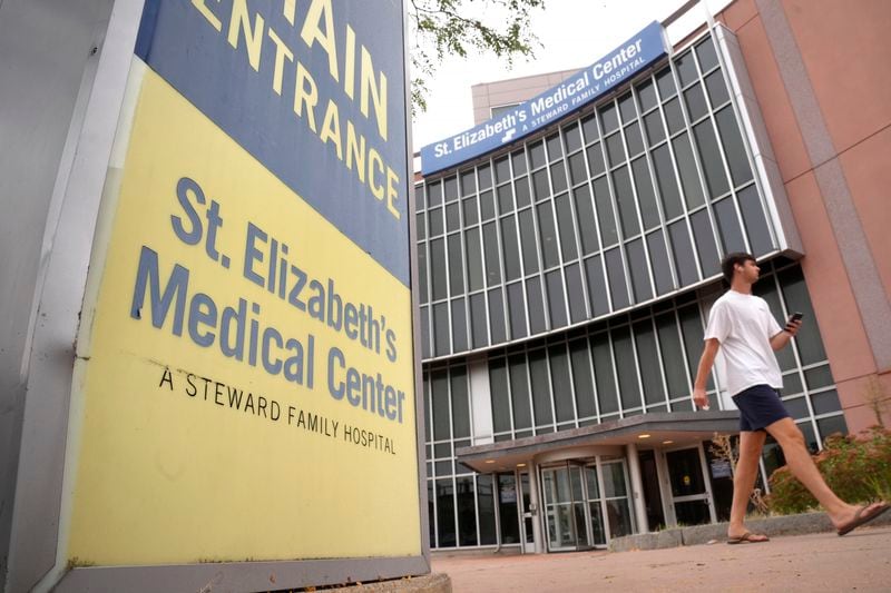 A passer-by walks past an entrance to St. Elizabeth's Medical Center, Thursday, Sept. 19, 2024, in the Brighton neighborhood of Boston. (AP Photo/Steven Senne)