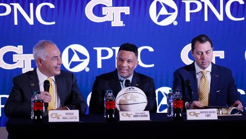 Georgia Tech President Ángel Cabrera (left) speaks to media members as he introduces new basketball coach Damon Stoudamire on Tuesday as athletic director J Batt looks on. (Miguel Martinez /miguel.martinezjimenez@ajc.com)