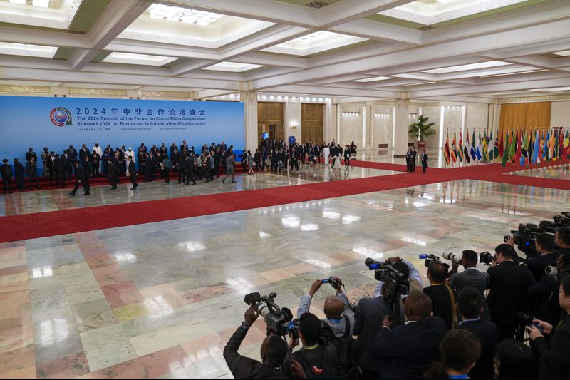 Journalists film China's President Xi Jinping and leaders from African countries as they prepare for a group photo session before the opening ceremony of the China Africa Forum at the Great Hall of the People in Beijing, Thursday, Sept. 5, 2024. (AP Photo/Andy Wong, Pool)